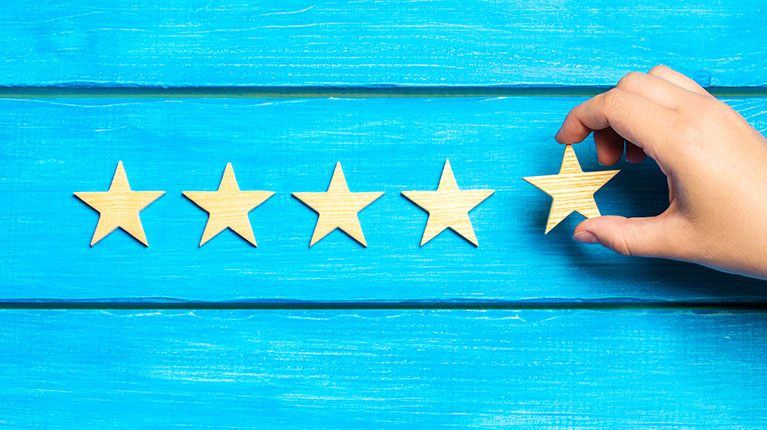 Hand adding the fifth star to mark five star quality.