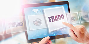 Person clicking a fraud button on an iPad