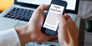 Person clicking a terms and conditions message on their phone.