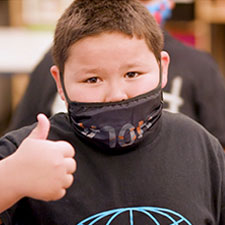 Kid giving a thumbs up