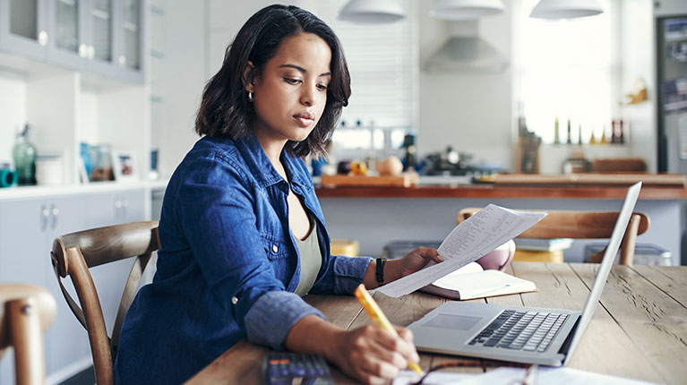 Woman who is writing something in a notebook.