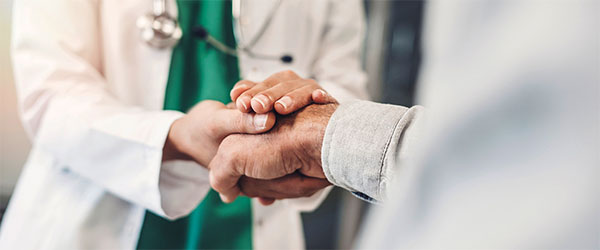 Doctor holding patient's hand