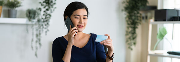 Woman looking at her insurance card