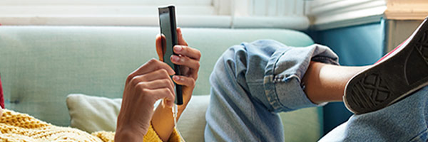 Women on couch looking at her phone