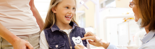 child getting a tooth sticker