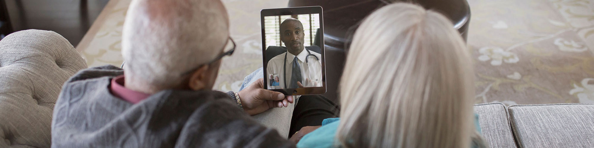 Two seniors on a video chat with doctor