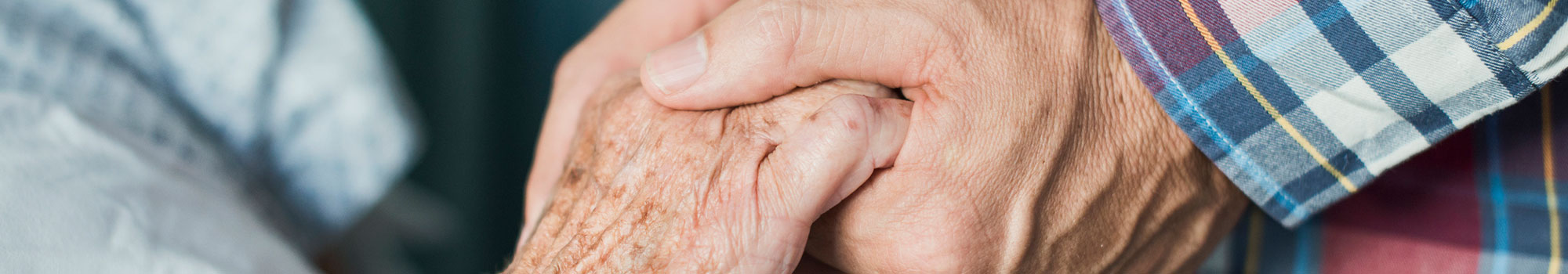 Close up of son holding his mothers hands