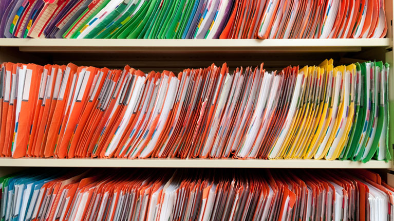Colorful folders on a shelf.