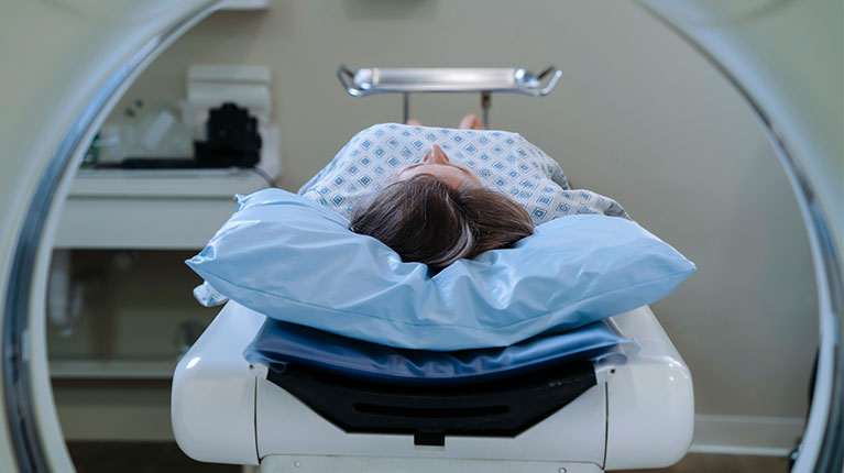 Woman getting a CAT scan.