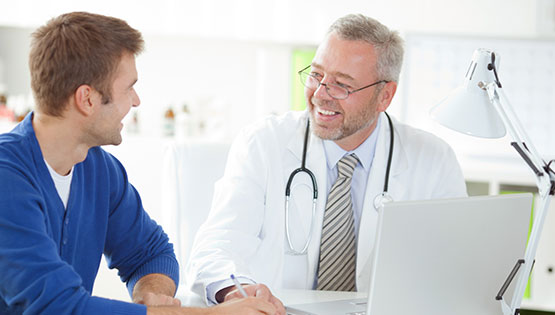 Male patient speaking to a male doctor.