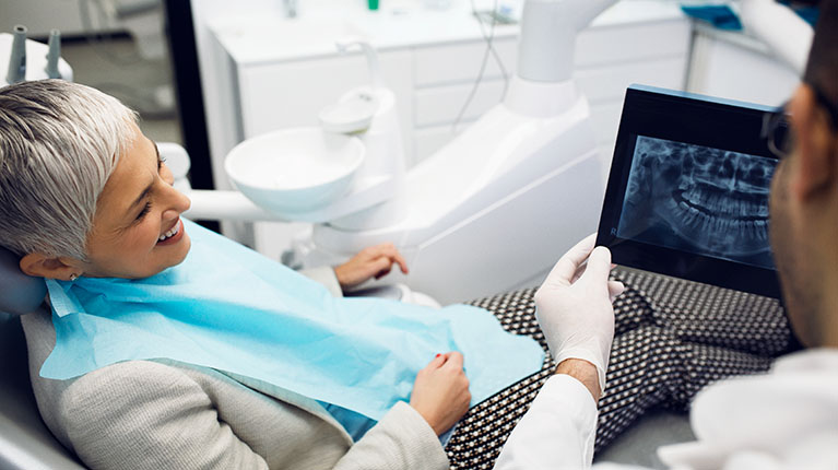 Woman reviewing X-ray with Dentist
