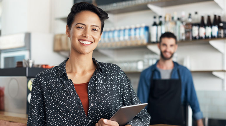 Two small business employees in their restaurant.