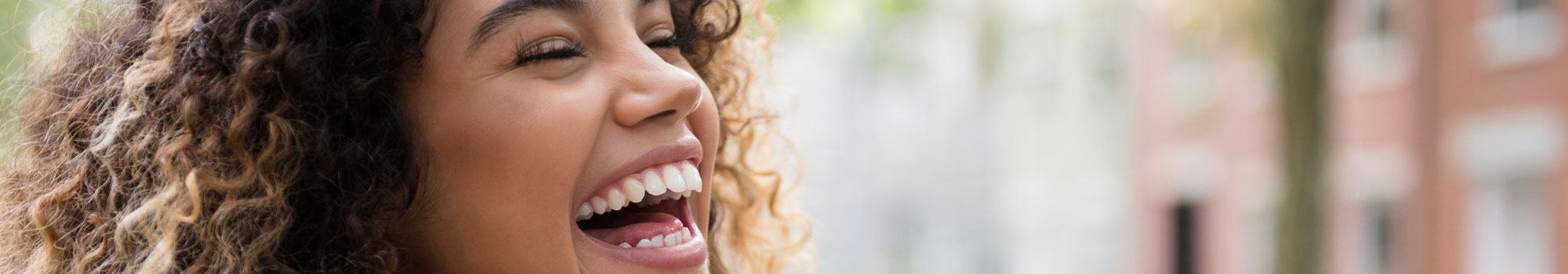 Woman with curly hair laughing