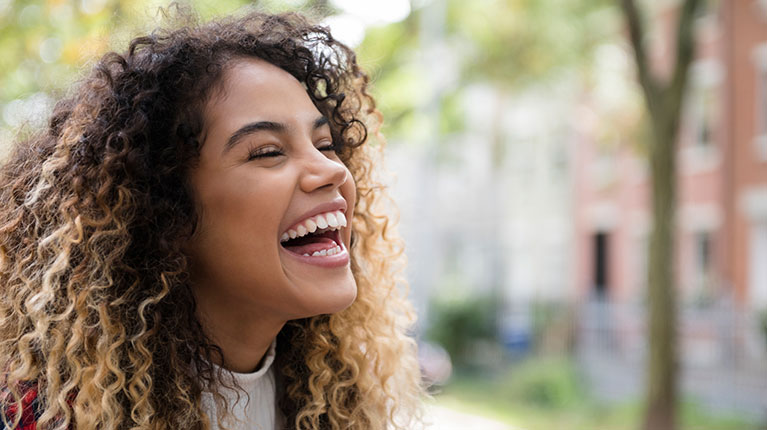 Woman with curly hair laughing