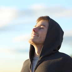 Teenage boy breathing in fresh air.